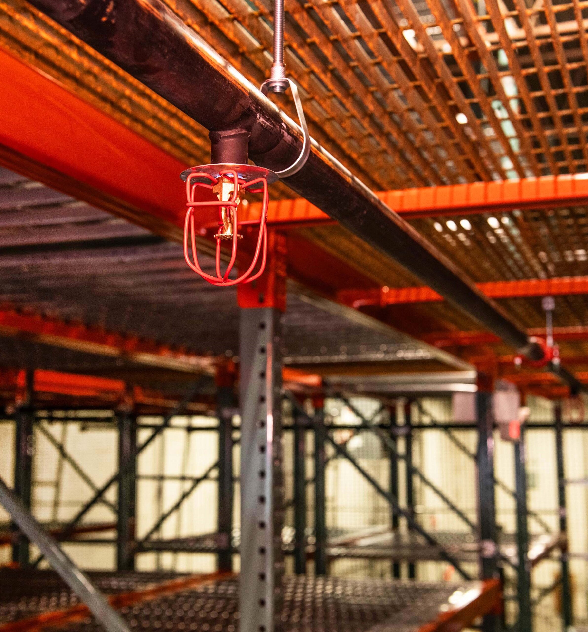 Fire sprinkler system inside of a warehouse racking system