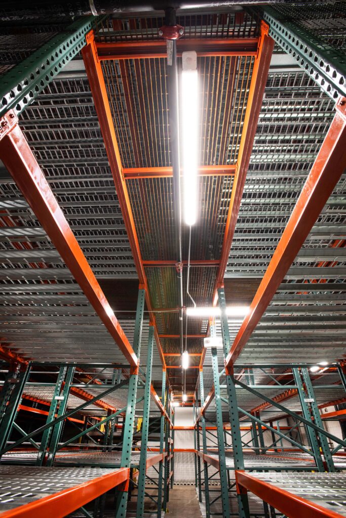 In-rack warehouse lighting on a catwalk racking system